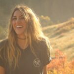 woman standing brown plants