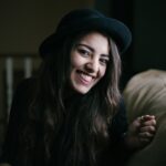 woman smiling while sitting on couch