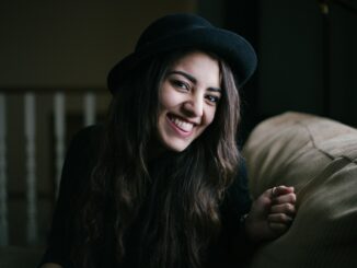 woman smiling while sitting on couch