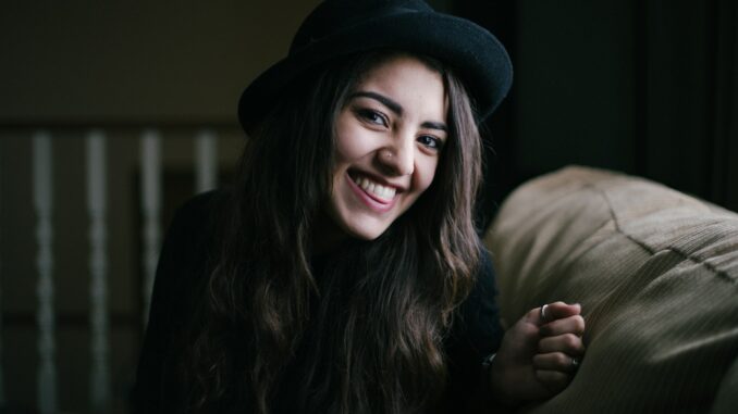 woman smiling while sitting on couch